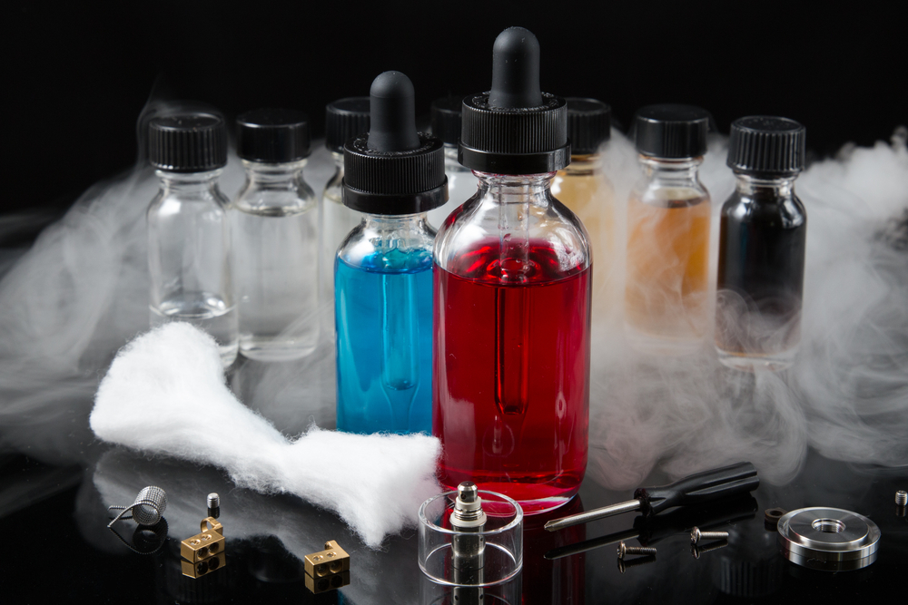 vape enthusiast accessories, DIY e-liquid mixing kit, person with multiple vape liquid bottles - DIY Vaping: Properly Mixing Multiple Flavor Concentrates into a ...